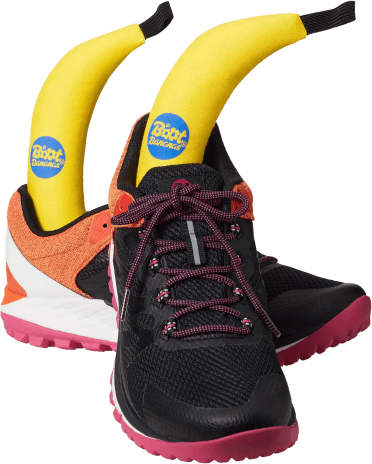 A pair of brightly coloured trainers with a Boot Banana inserted in each. The Boot Banana is a banana-shaped deodoriser made of yellow fabric that pushes all the way down into the toe of the shoe, with one end protruding visibly from the top.