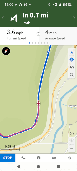 A screenshot of Komoot's navigation app interface taking the user along a pre-uploaded GPX track. It displays current speed and average speed and highlights an upcoming turn the user needs to make.