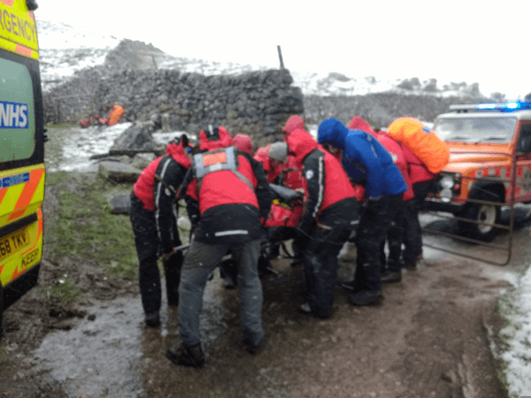 Mountain Rescue lift the stretcher.